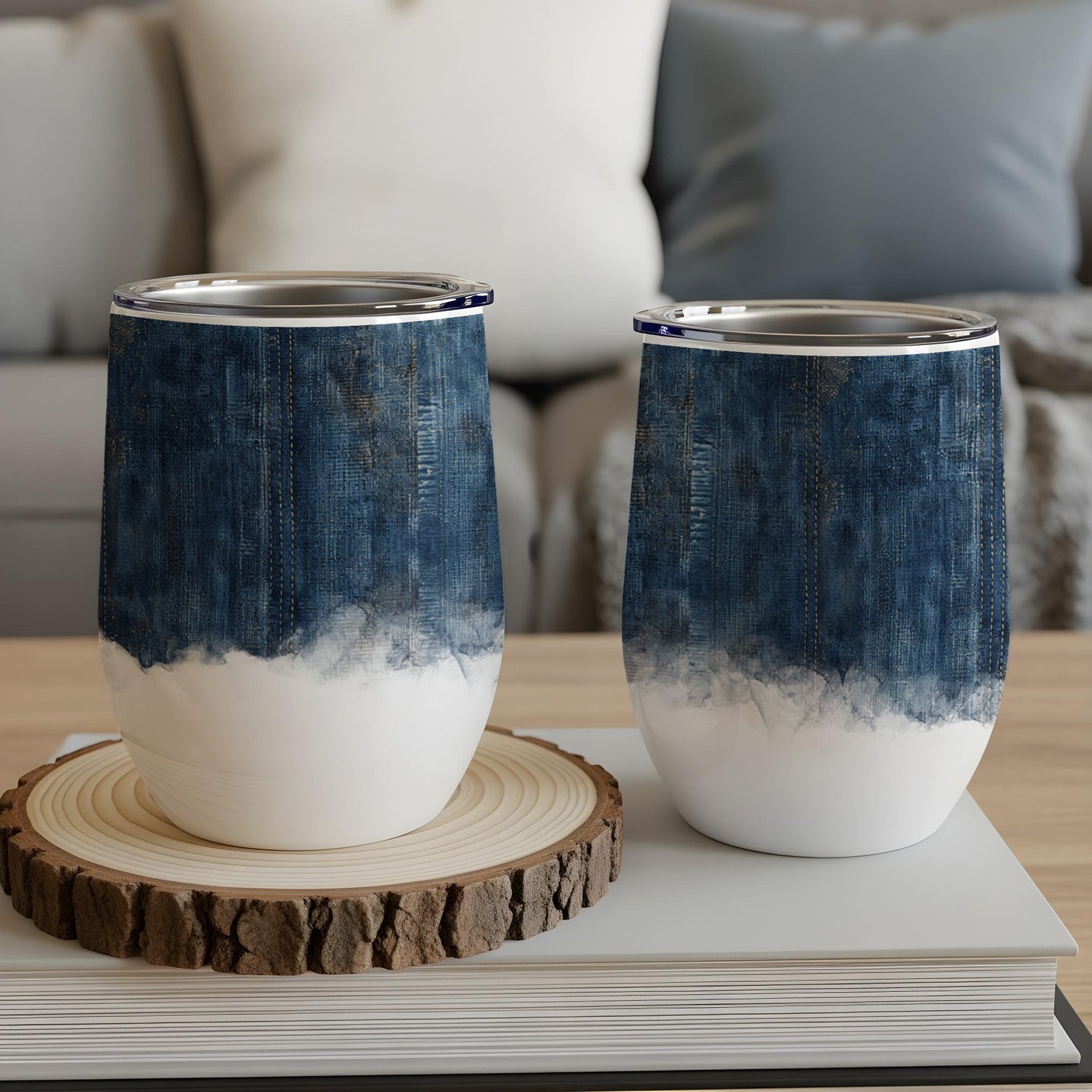 Two tumblers with denim-inspired design on a wooden coaster.