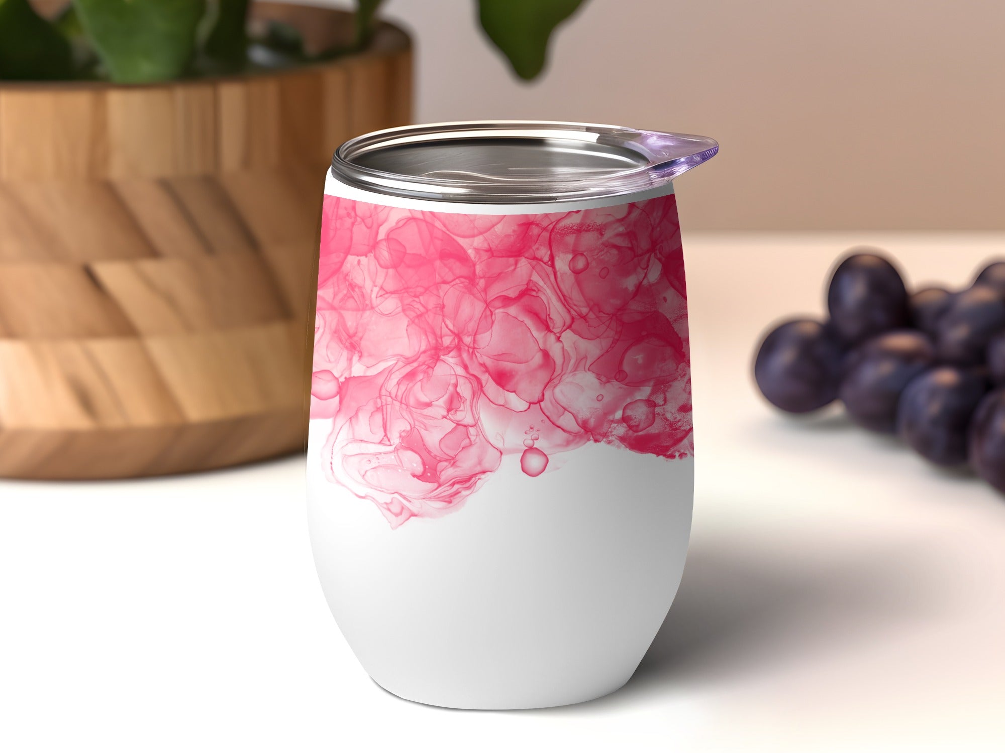 White tumbler with pink abstract alcohol ink design.