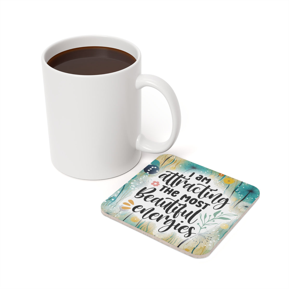 White mug and coaster with "I am attracting the most beautiful energies" text.