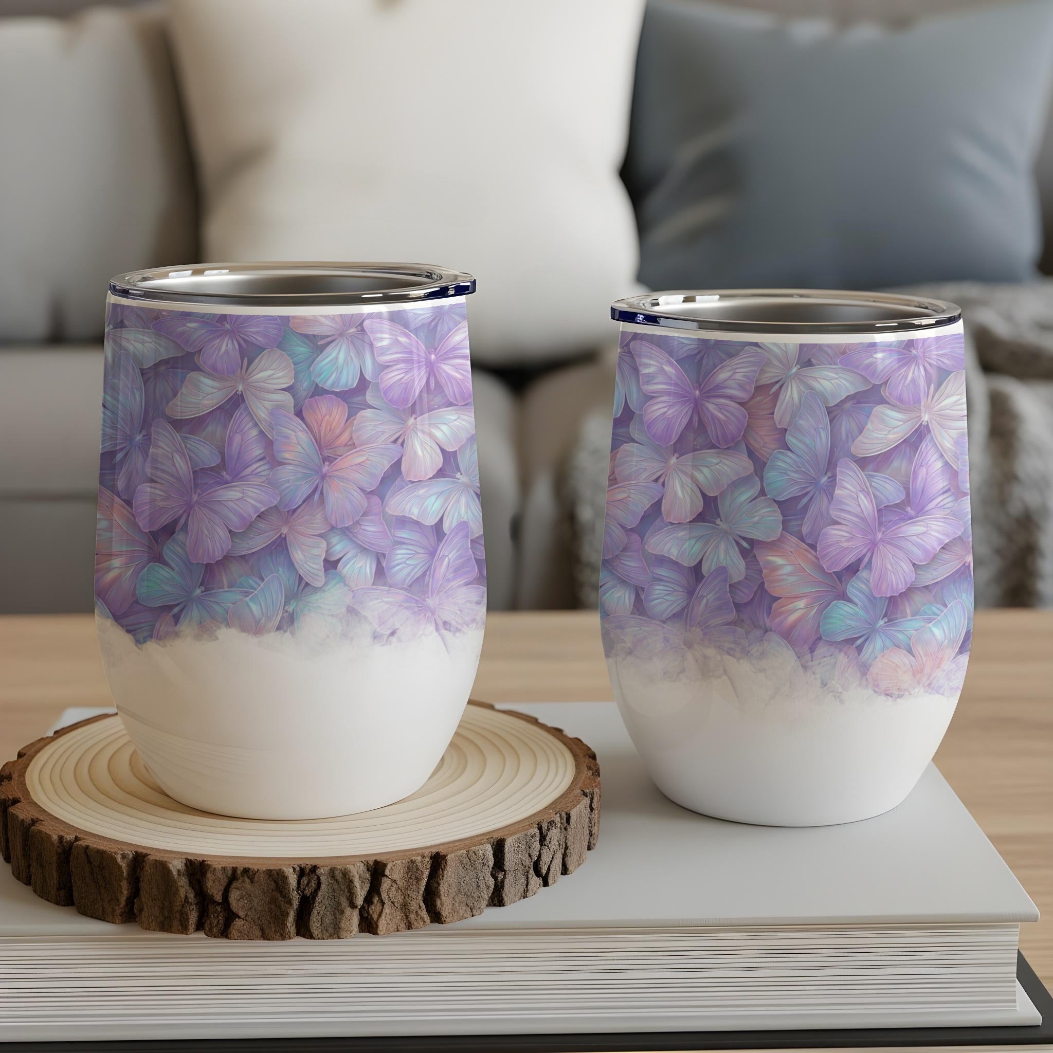 Two insulated tumblers with a pastel butterfly pattern.