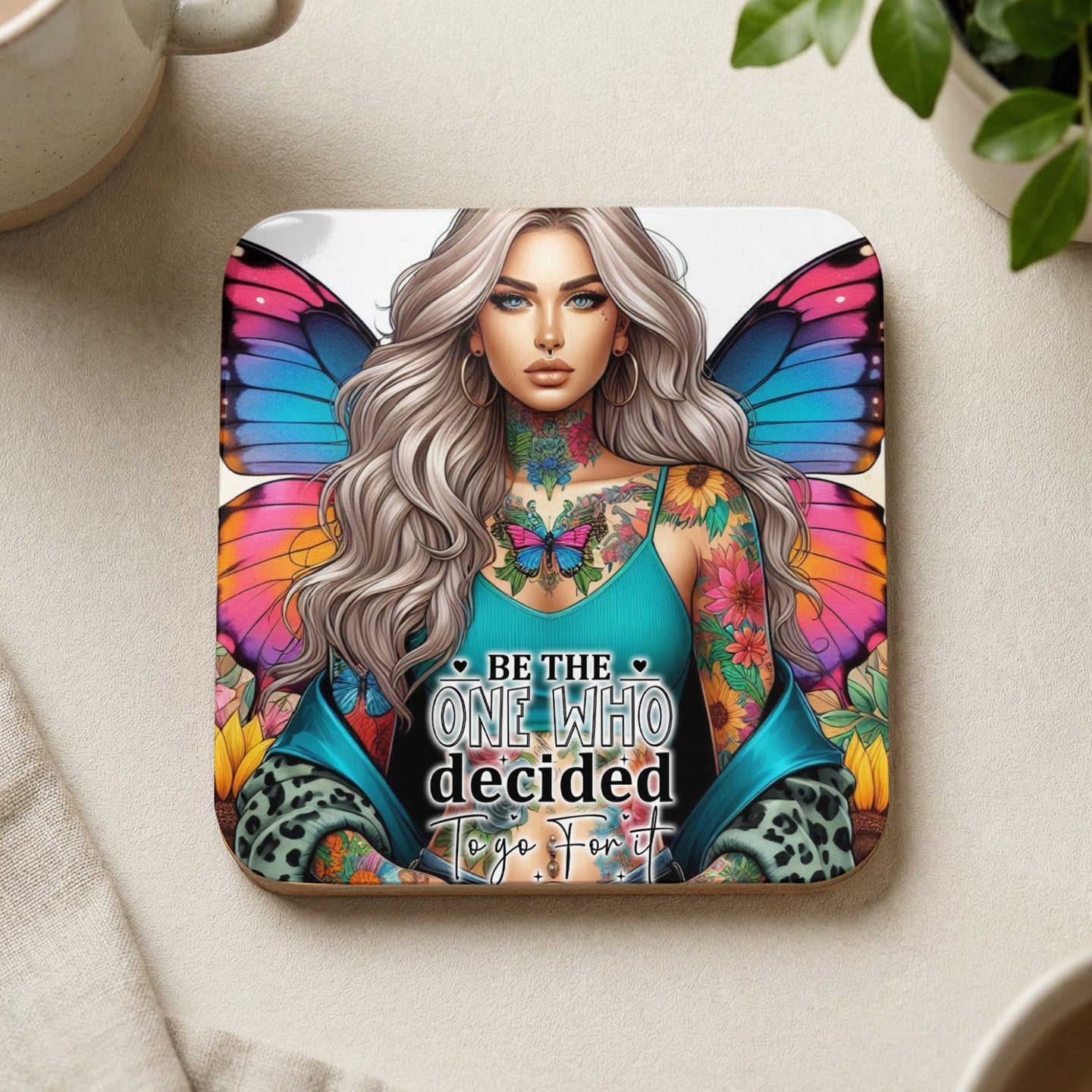 Square coaster with a woman's portrait featuring butterfly wings and the text "Be the one who decided to fly".