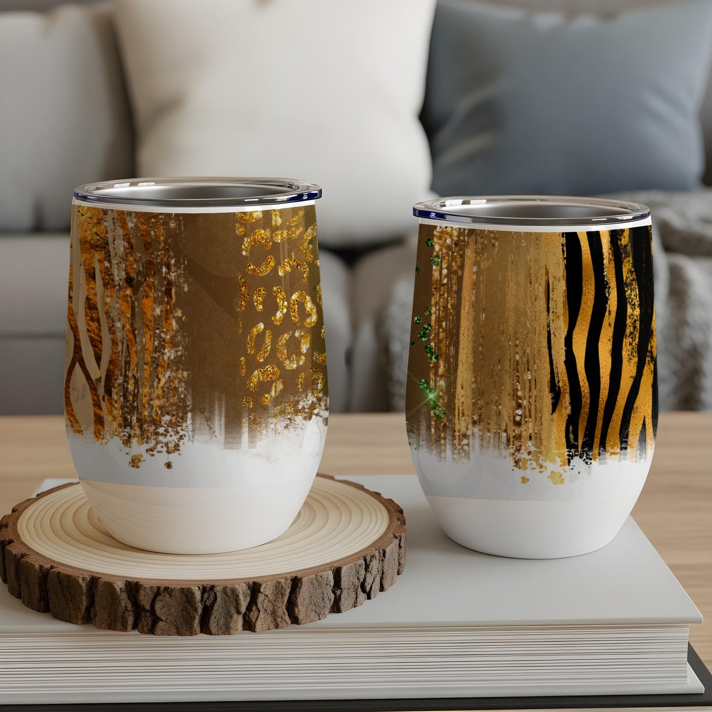 Two stemless wine tumblers with abstract animal print and glitter designs.