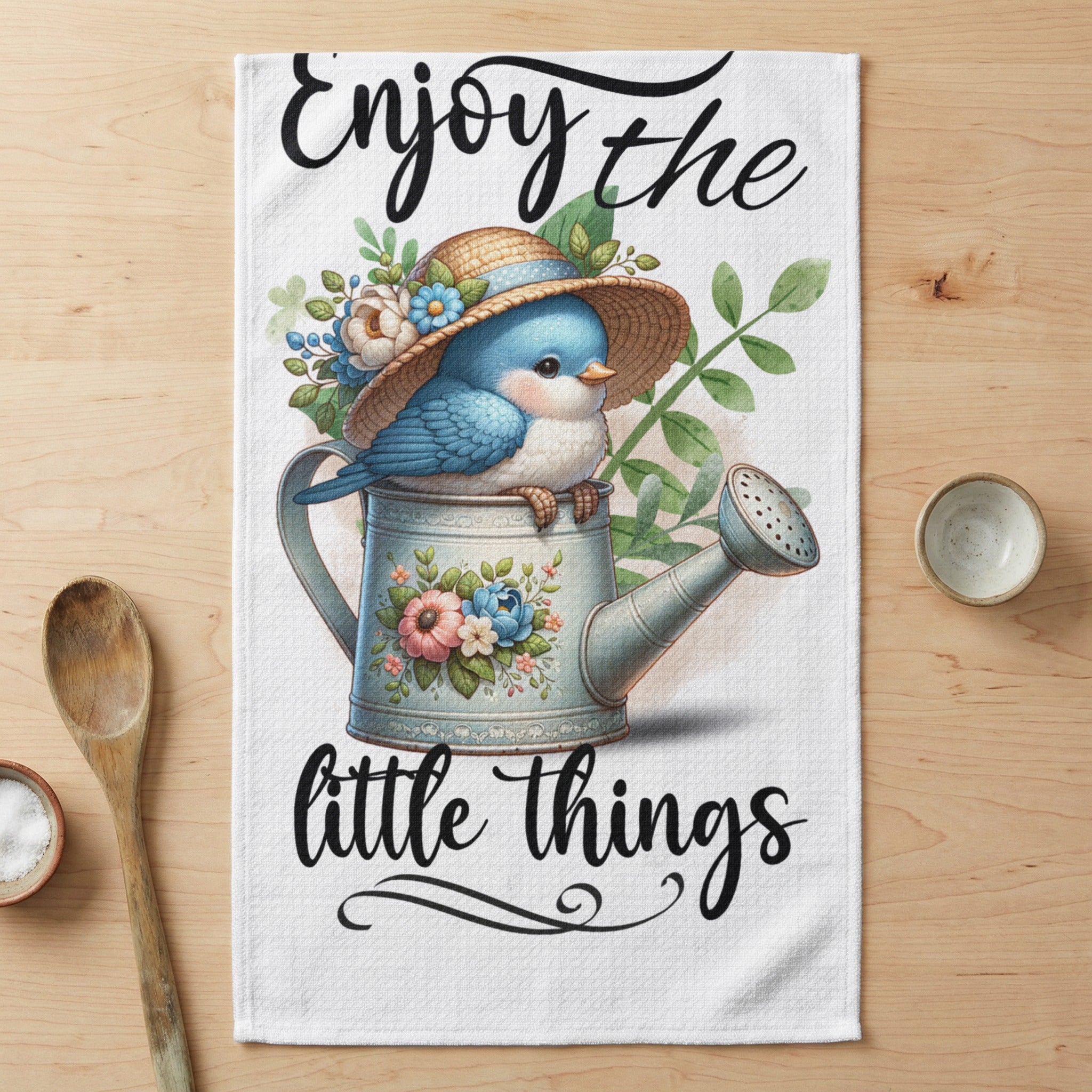 Bluebird on watering can wearing a straw hat, "Enjoy the little things" text.