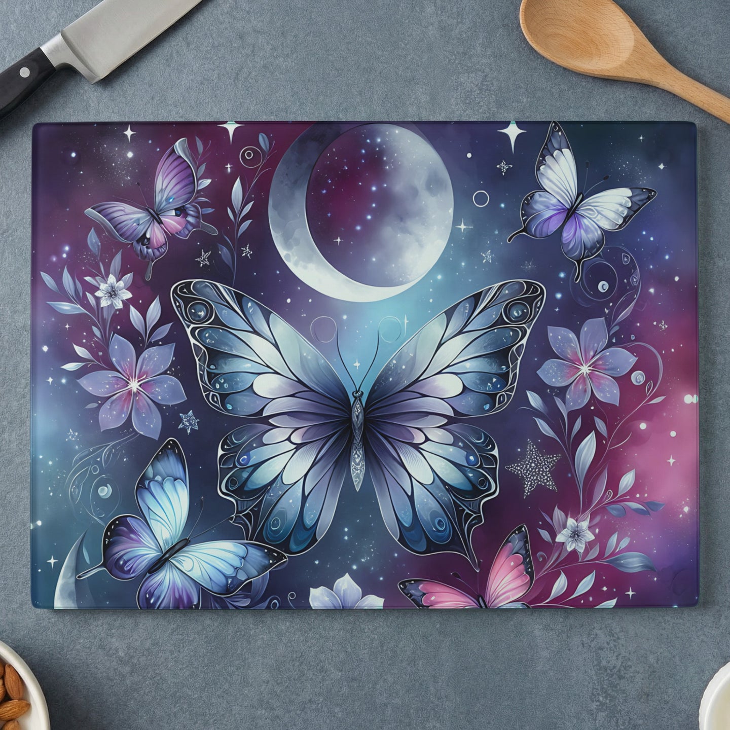Butterfly and moon pattern on a glass cutting board.