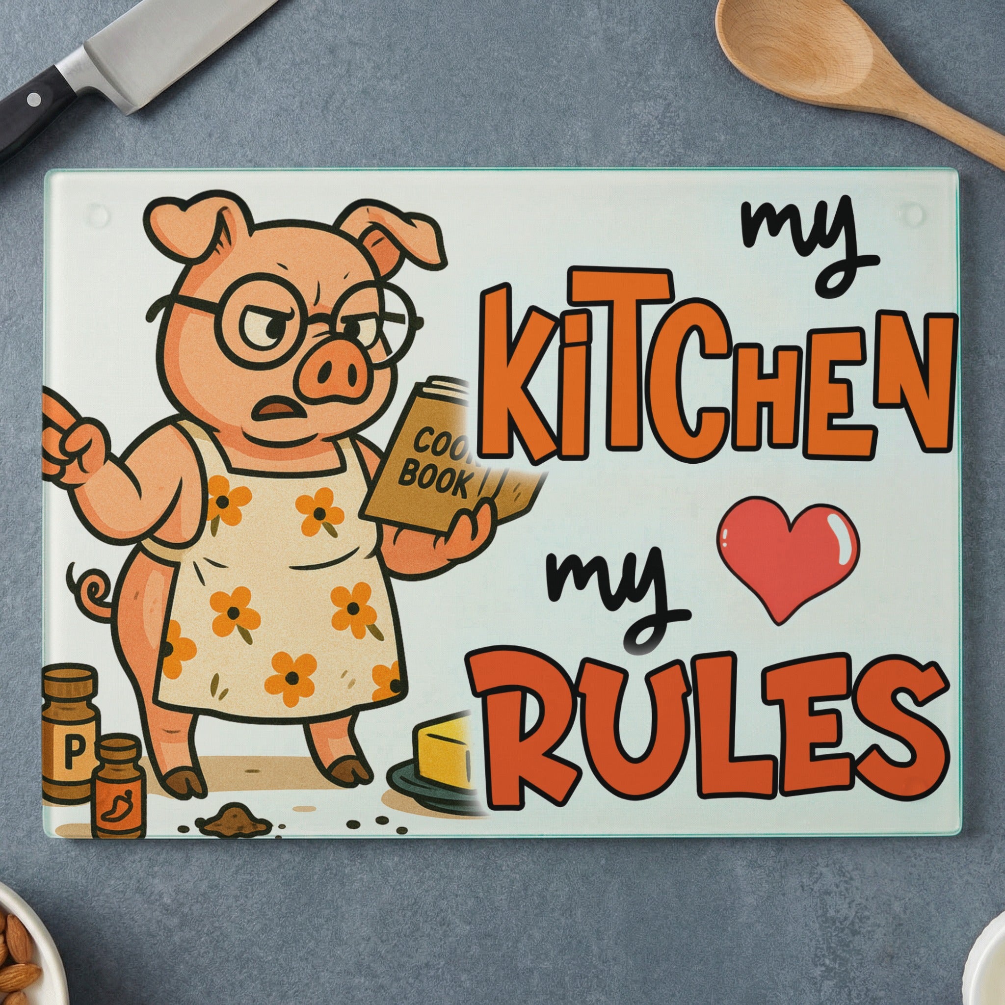 Pig in an apron holding a cookbook, text reads "my Kitchen my Rules".