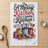 "A Messy Kitchen is a happy Kitchen" tea towel with utensils and colorful cupcakes.
