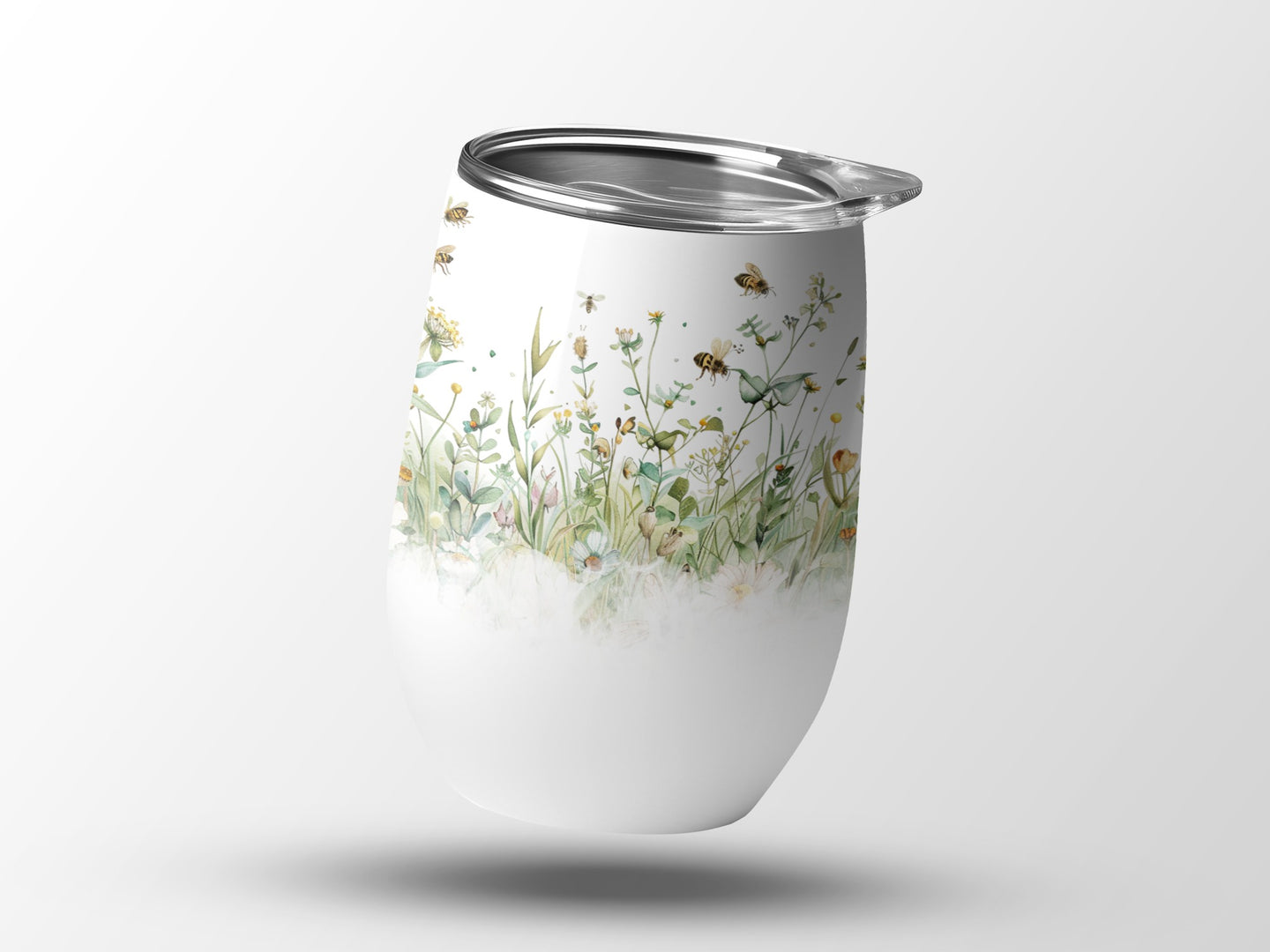 White tumbler with watercolor bees and wildflowers.
