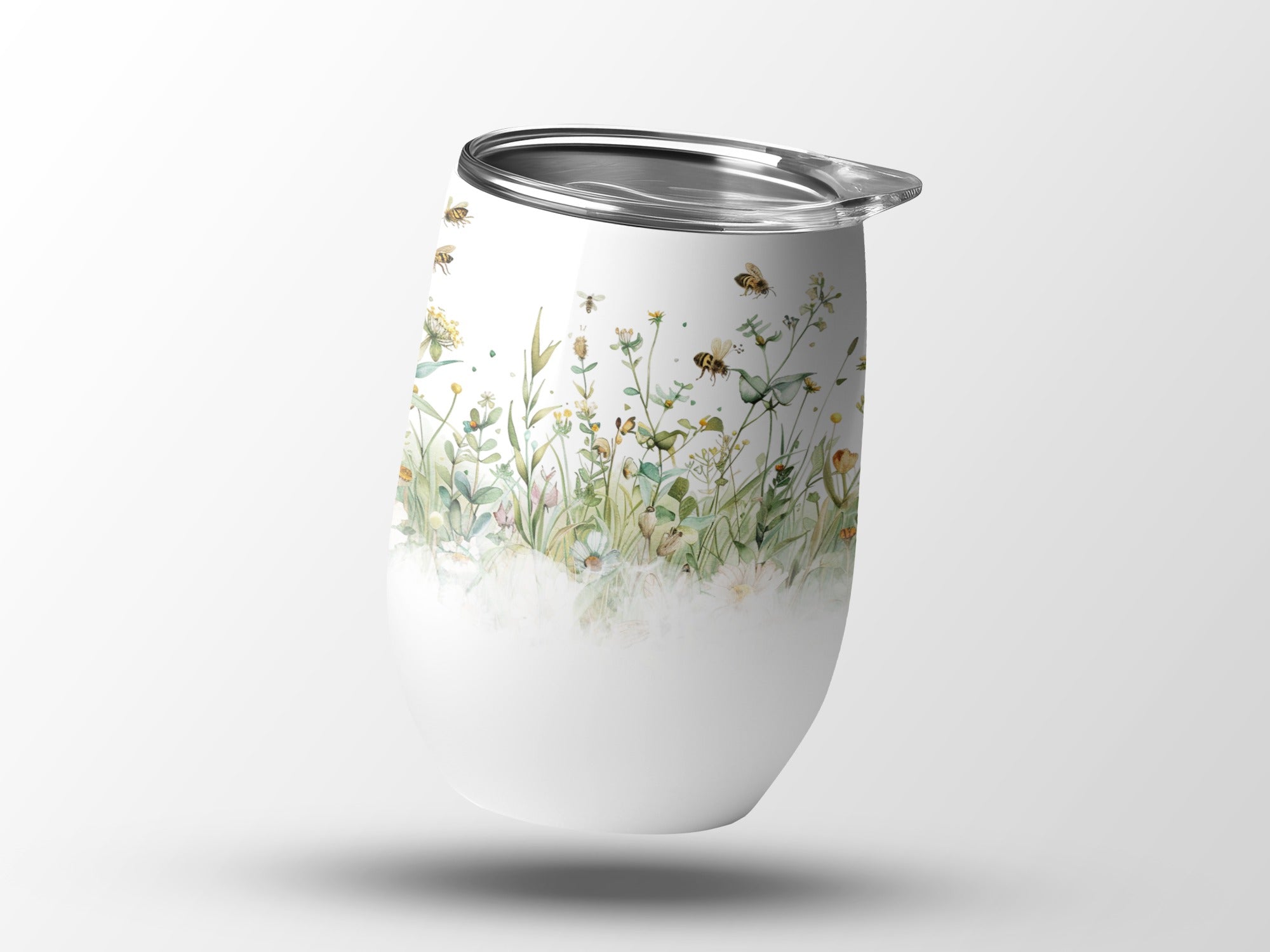 White tumbler with watercolor bees and wildflowers.