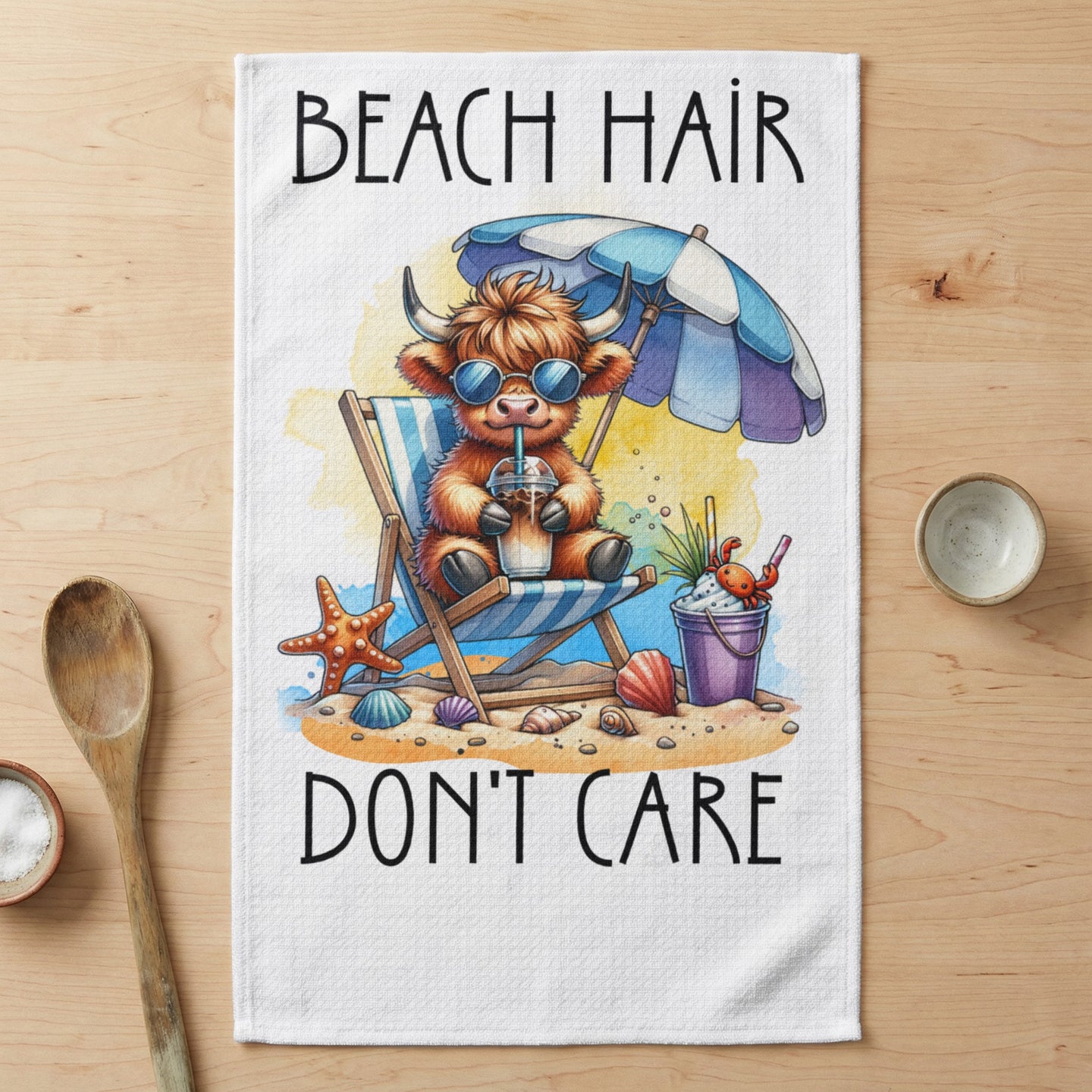 Highland cow in beach chair with sunglasses and drink, text "BEACH HAIR DON'T CARE."