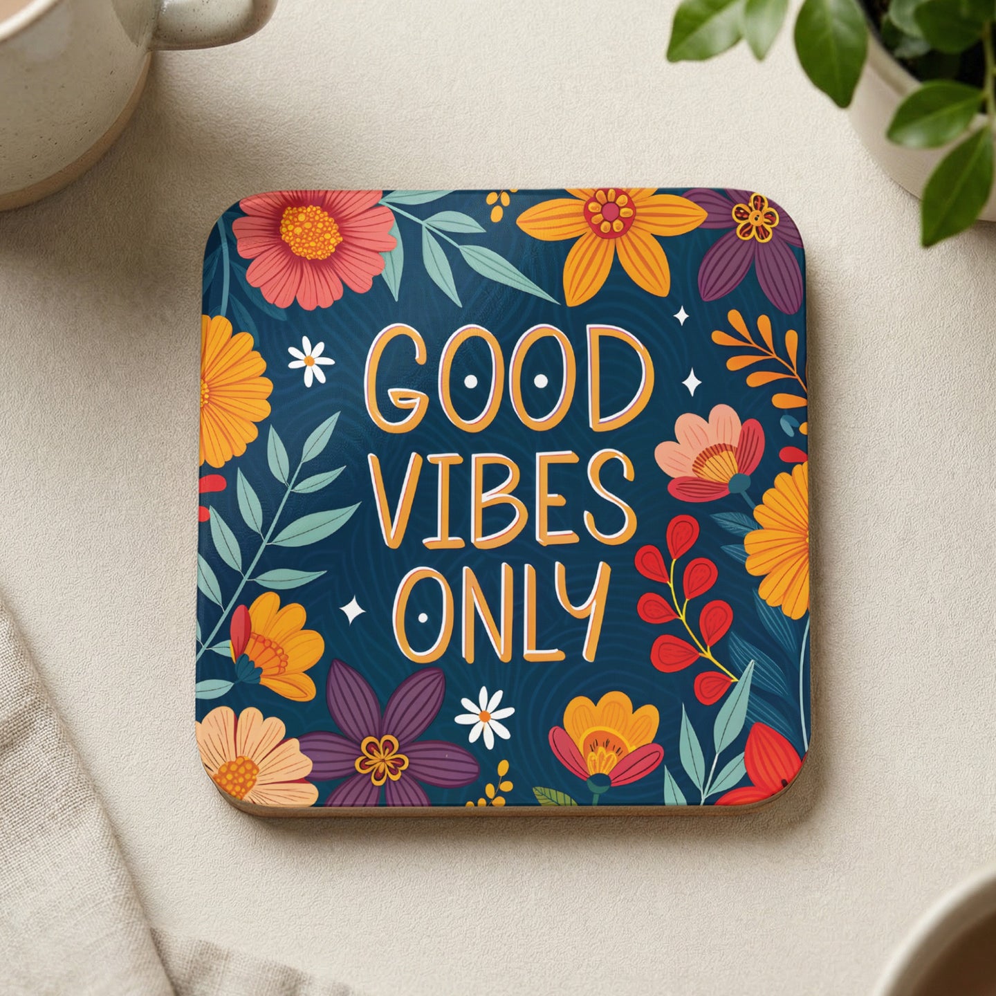 Coaster with "GOOD VIBES ONLY" text surrounded by colorful floral illustrations on a dark blue background.