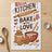 Kitchen towel with "In This Kitchen We Bake With Love" text and baking illustrations.