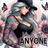 Tattooed woman in a black crop top and baseball cap, with sunflowers and butterflies.