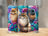 Three tumblers featuring majestic cats with blue and purple floral accents.