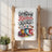 Kitchen towel with "A messy kitchen is a happy kitchen" text and colorful mugs and cupcakes.
