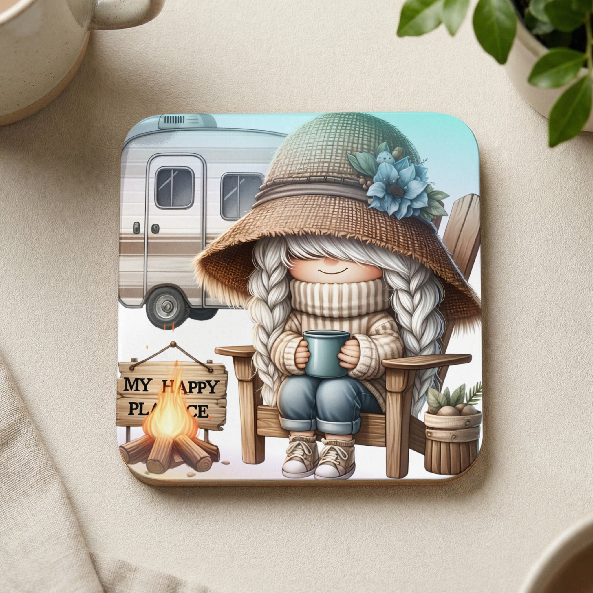 Gnome in hat and sweater sits in chair with mug, camper and campfire behind.