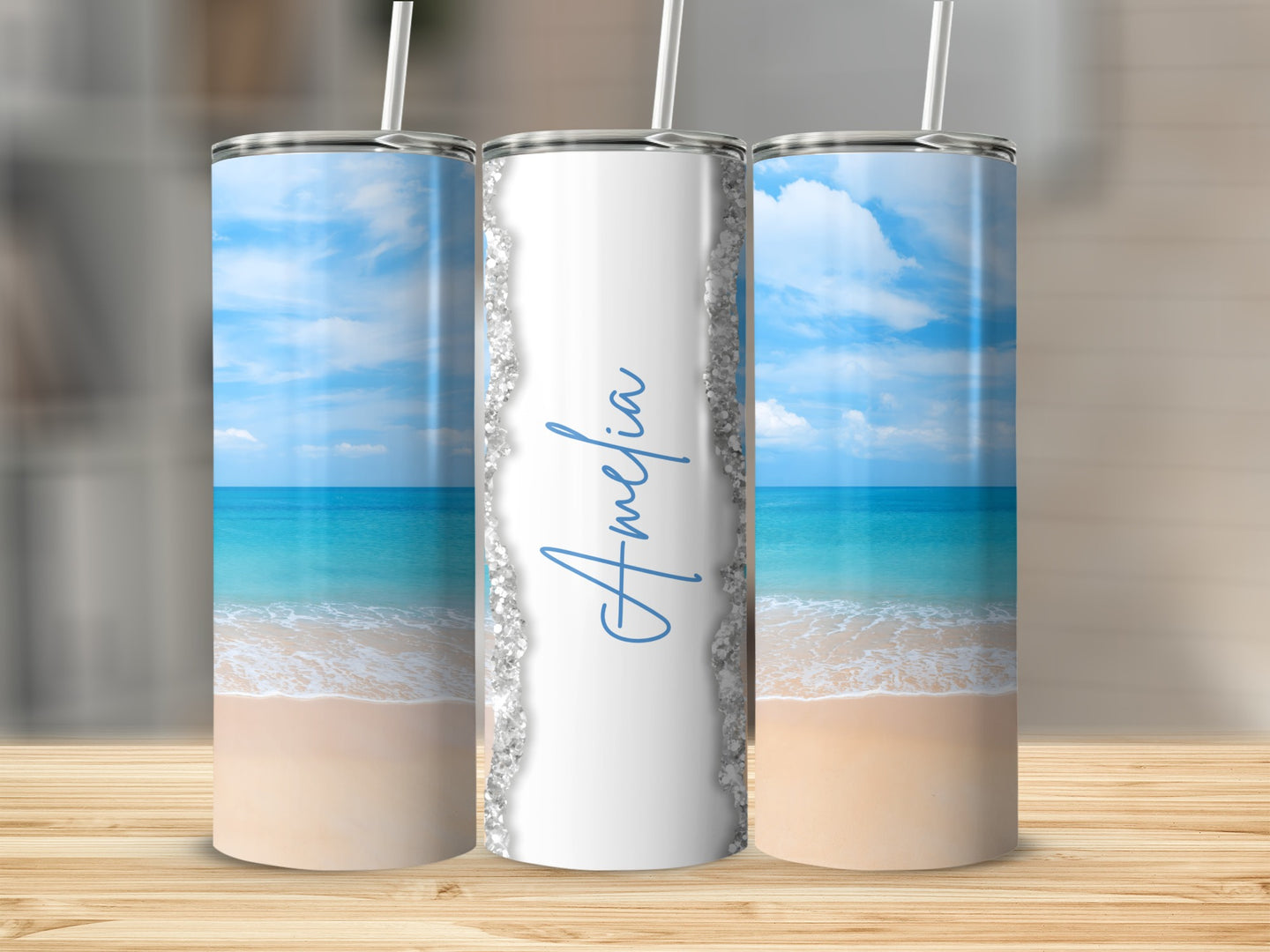 Tall tumbler with beach scene and "Amelia" in script.