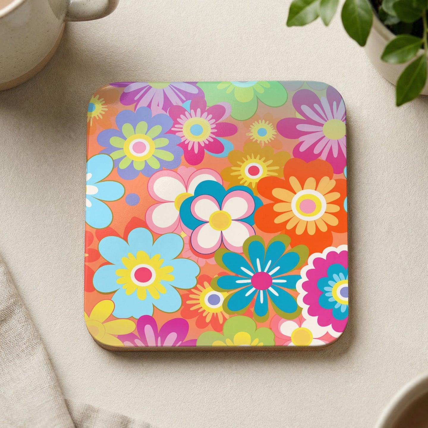 Square coaster with colorful retro floral pattern on orange background.