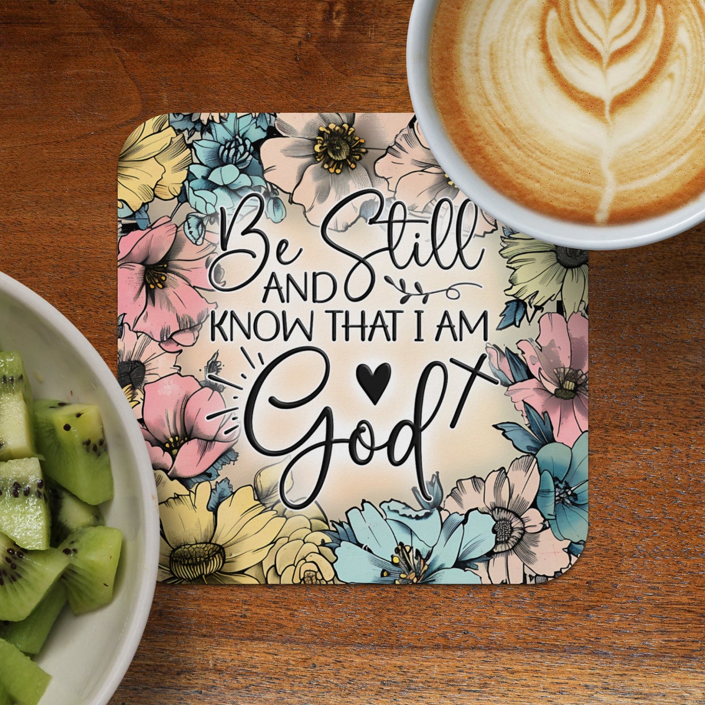 Coaster with "Be Still and Know That I Am God" text surrounded by flowers.