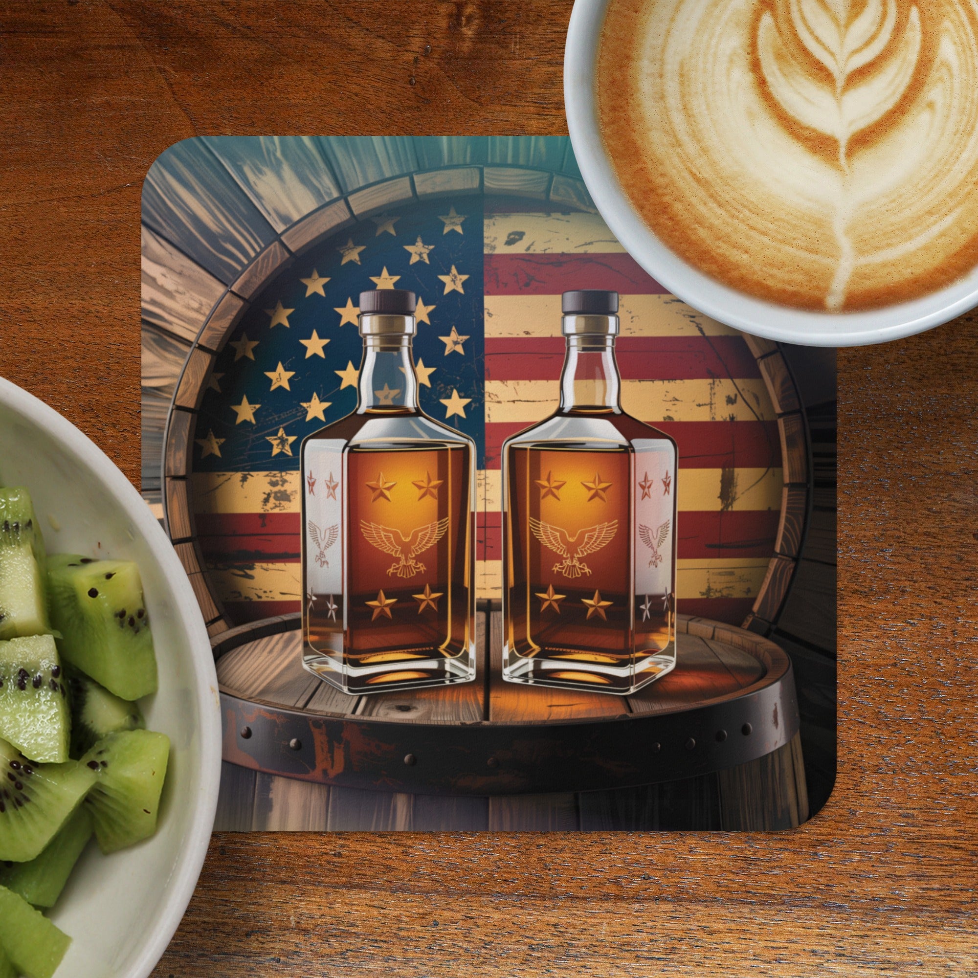 Two whiskey bottles on a barrel with an American flag background, beside fruit and coffee.