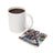 White mug beside a coaster featuring a woman with tattoos and sunflowers, text reads "You are CAPABLE".