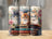 Three kittens with books and roses on tumblers.