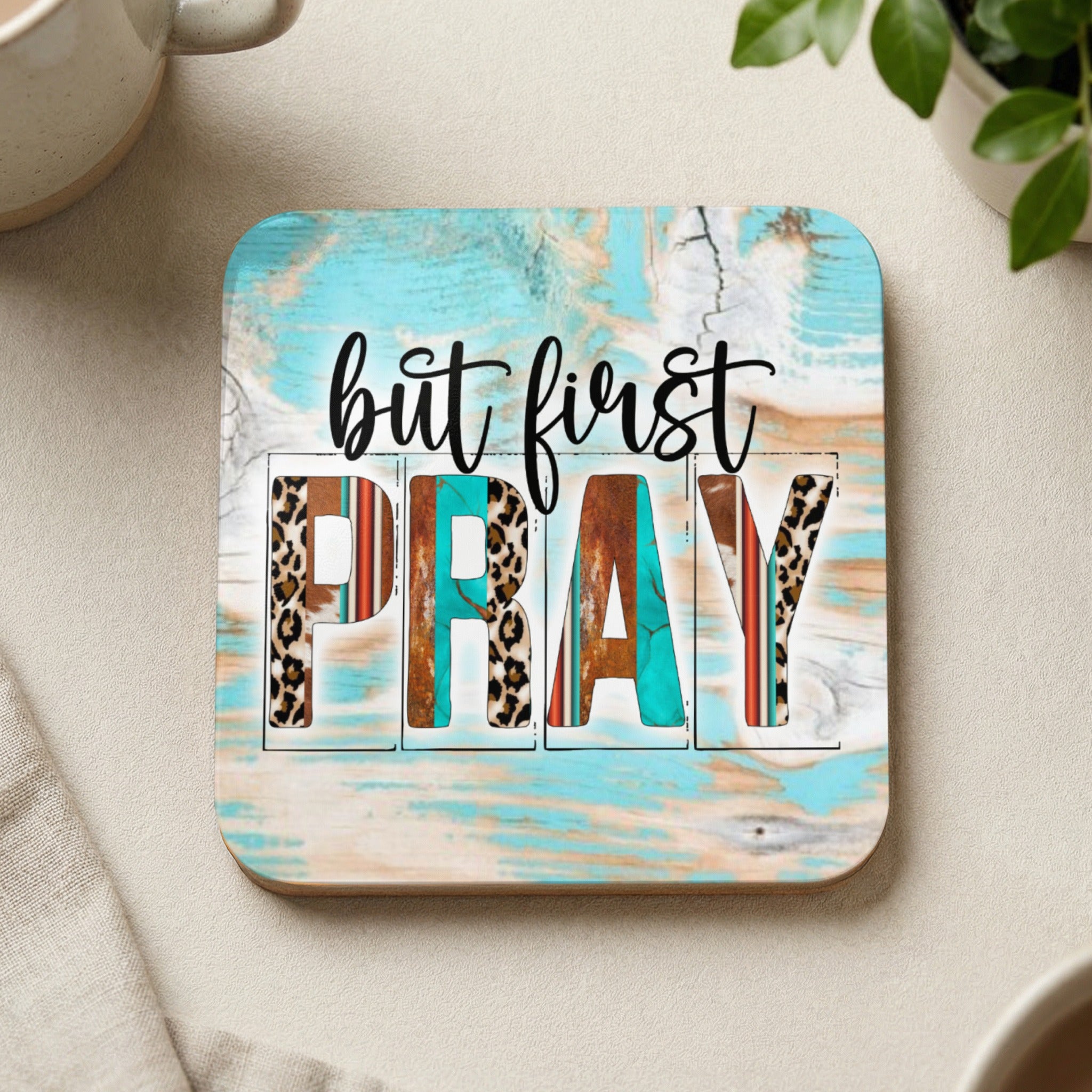 Square coaster with "but first PRAY" in distressed wood and animal print letters.