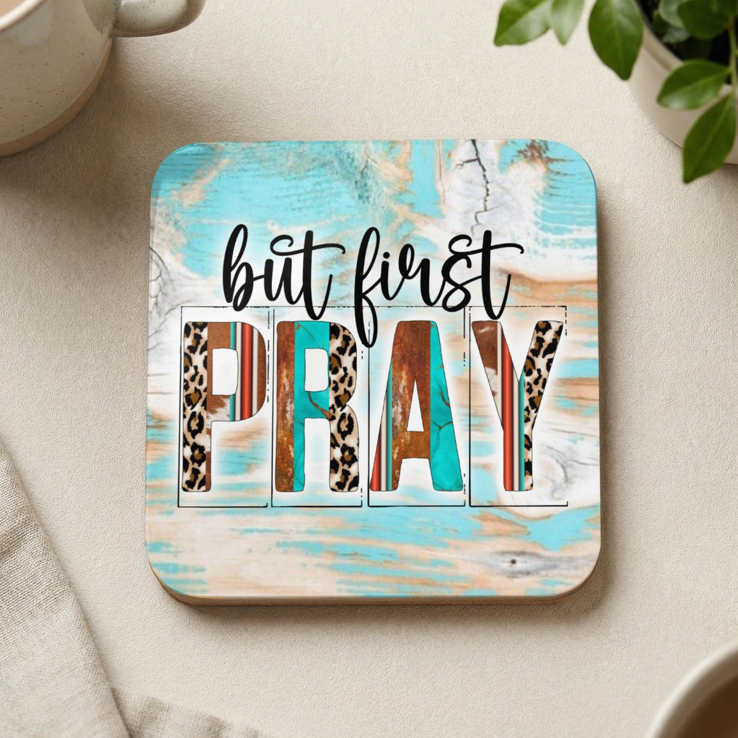 Square coaster with "but first PRAY" in distressed wood and animal print letters.