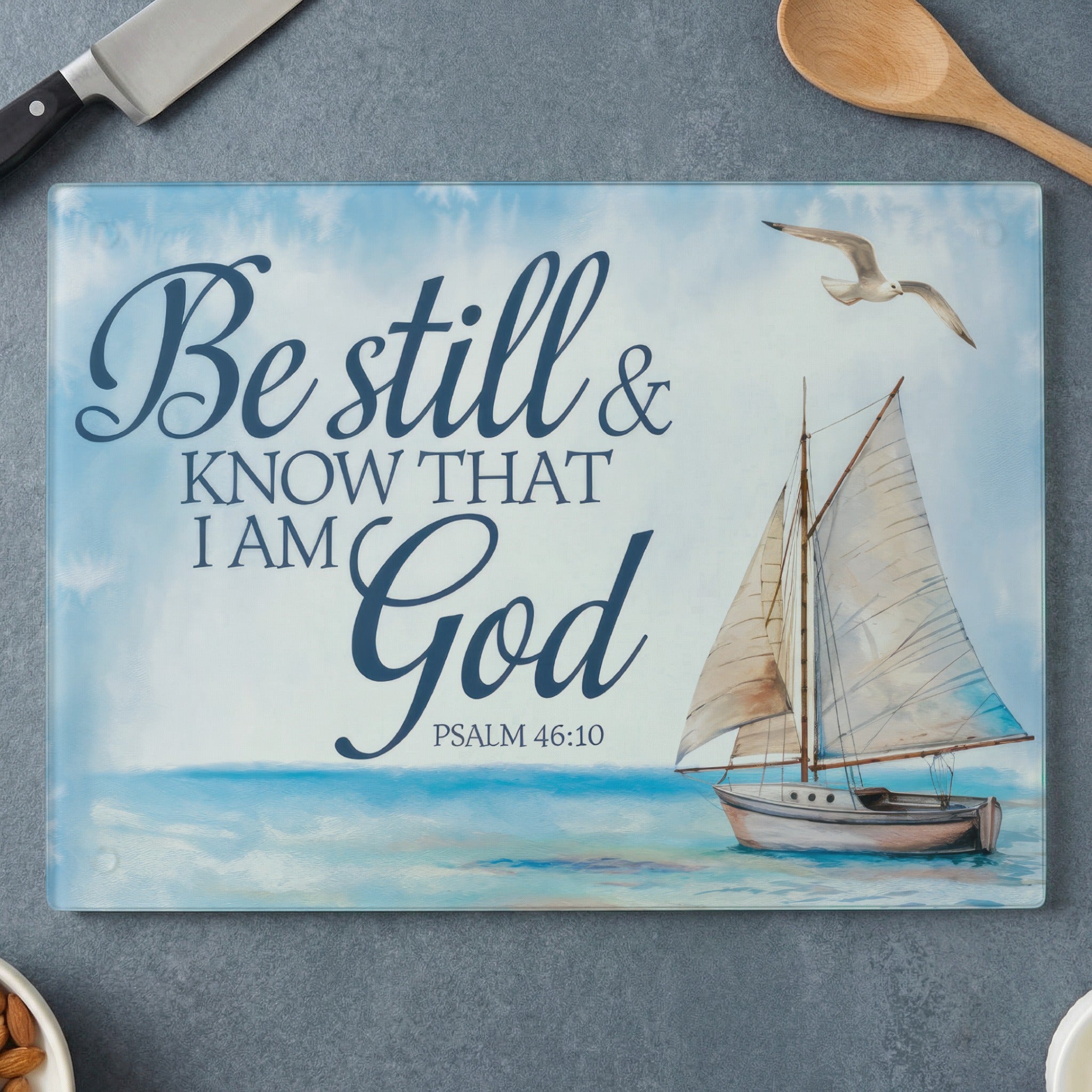 Sailboat on ocean with text "Be still & know that I am God Psalm 46:10".
