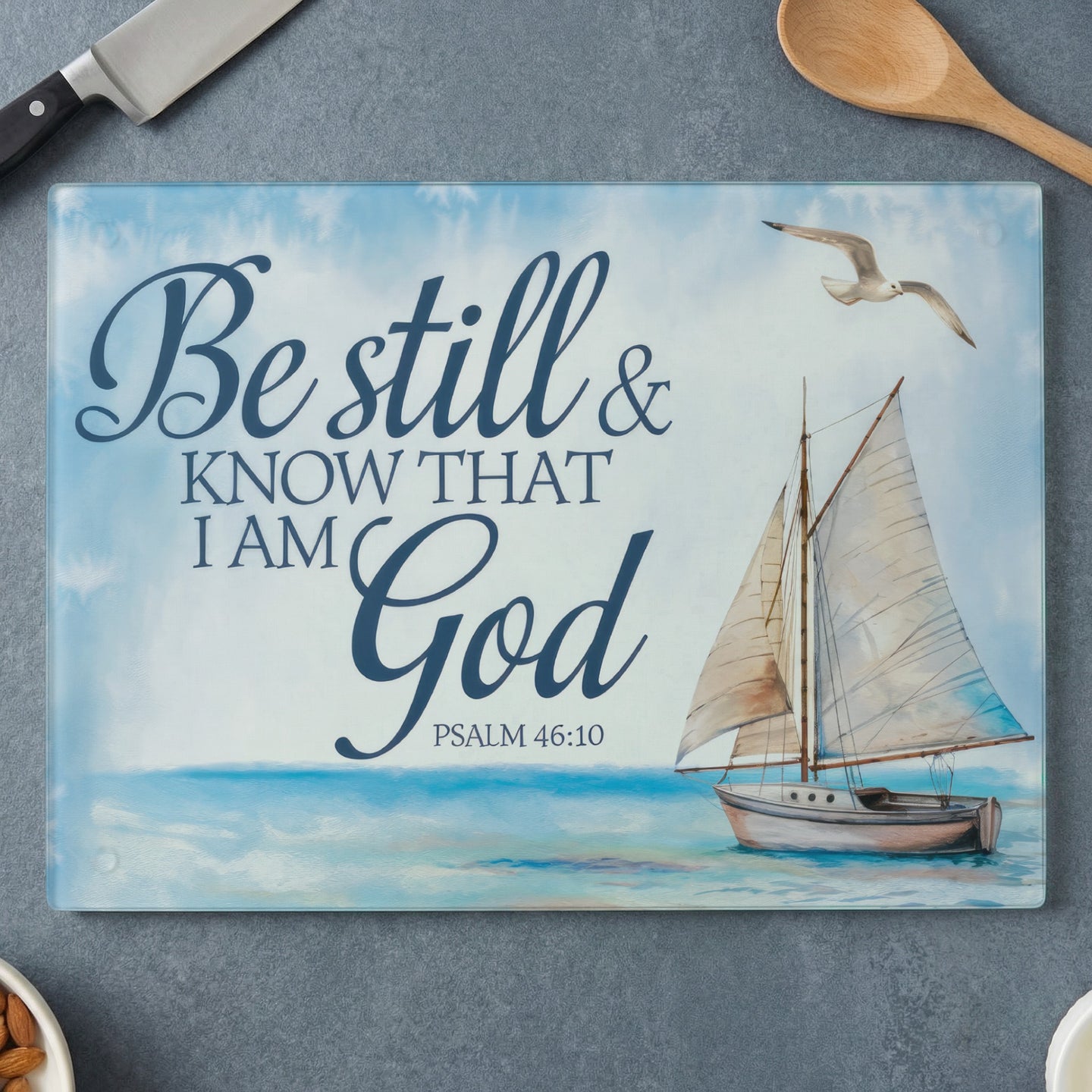 Sailboat on ocean with text "Be still & know that I am God Psalm 46:10".