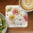 Coaster with daisies and text "I AM CONNECTED TO THE UNIVERSE".