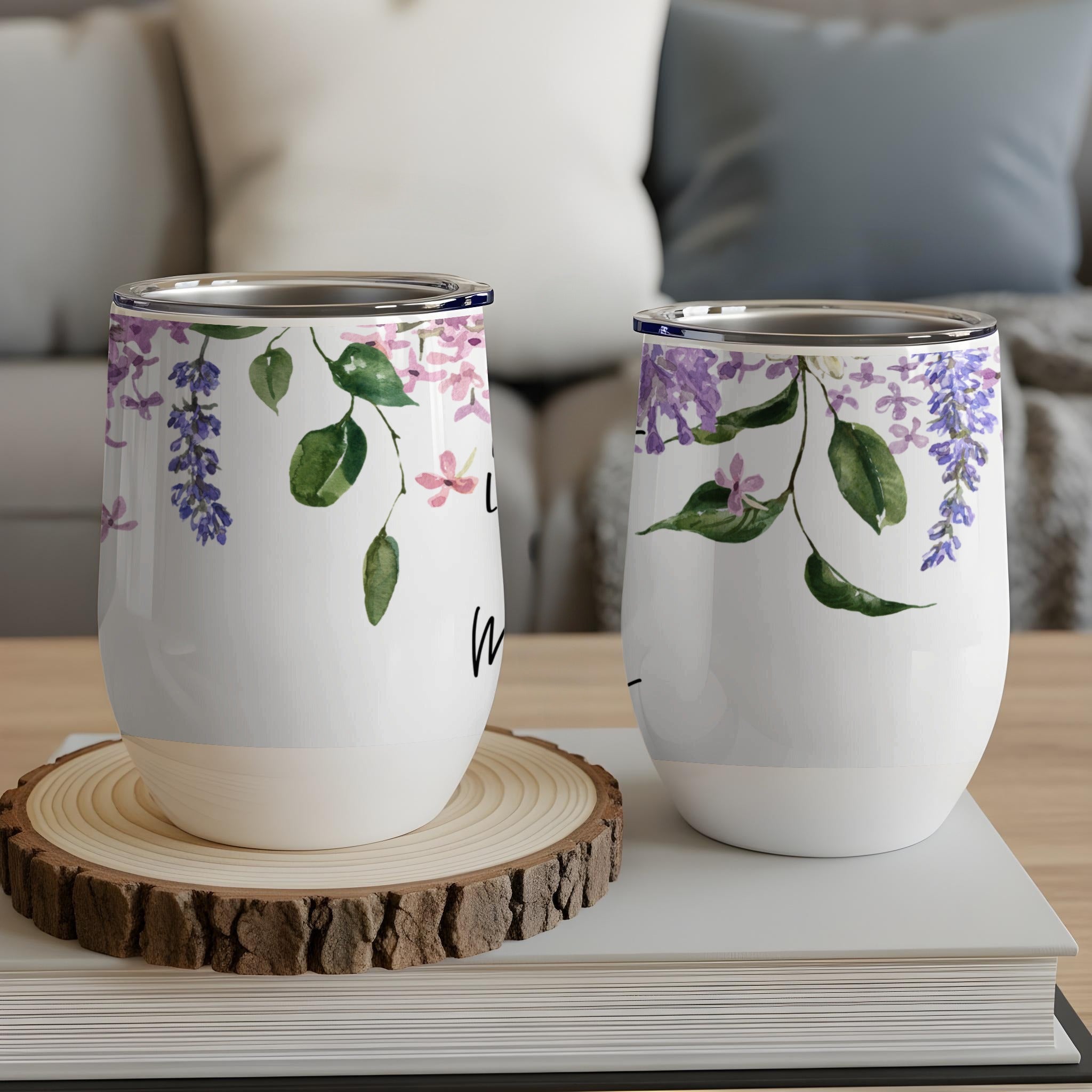 Two white tumblers with purple floral and vine design.