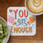 "You are enough" quote with hearts on a coaster next to a kiwi fruit bowl and coffee.