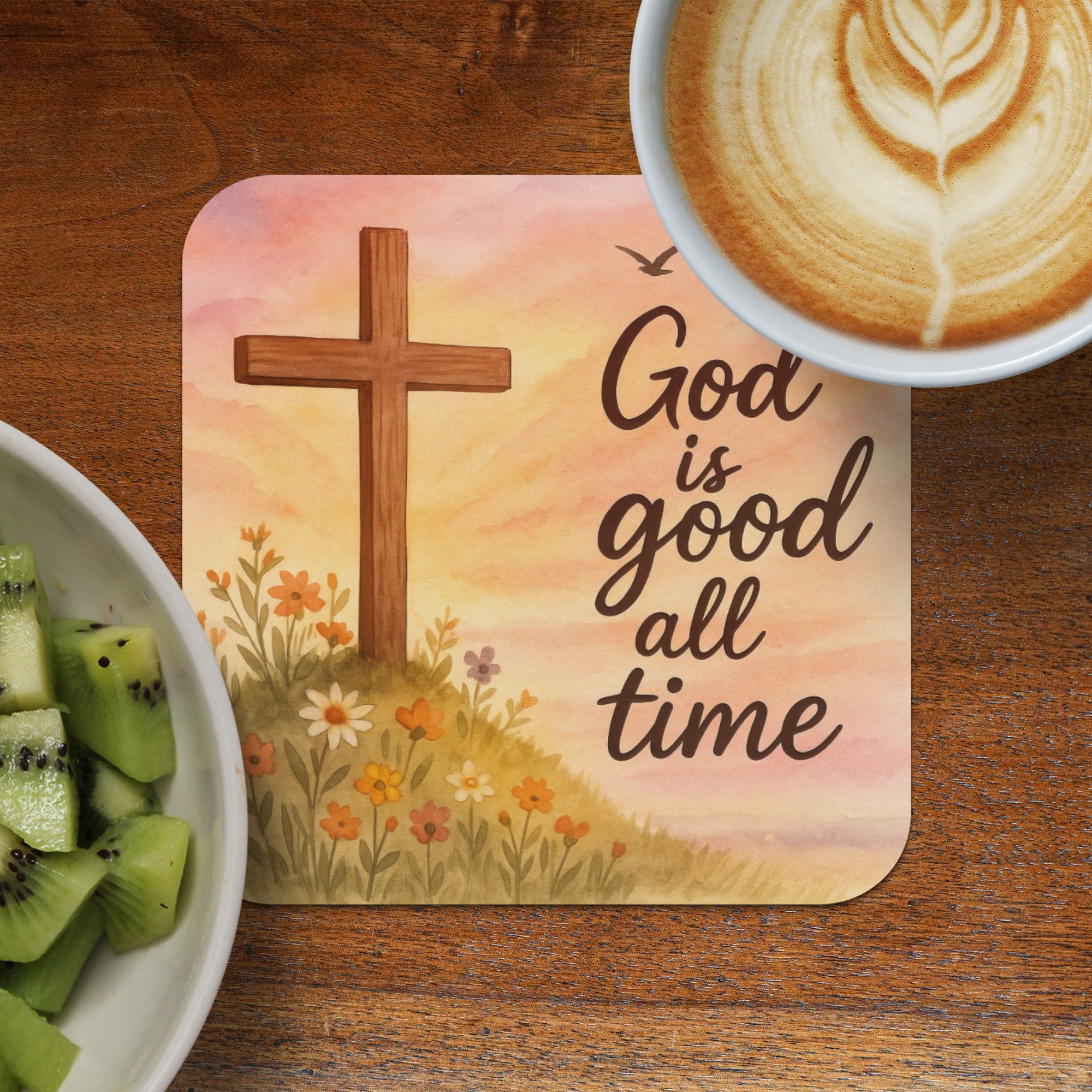 Cross with flowers and "God is good all time" text, coffee, and kiwi.