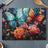 Two vibrant butterflies above colorful flowers on a dark background.