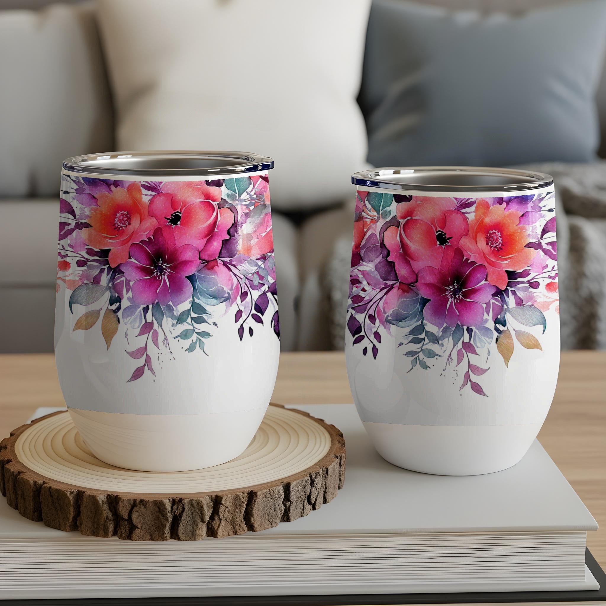 Two white tumblers with vibrant pink and purple floral designs.