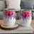 Two white tumblers with vibrant pink and purple floral designs.
