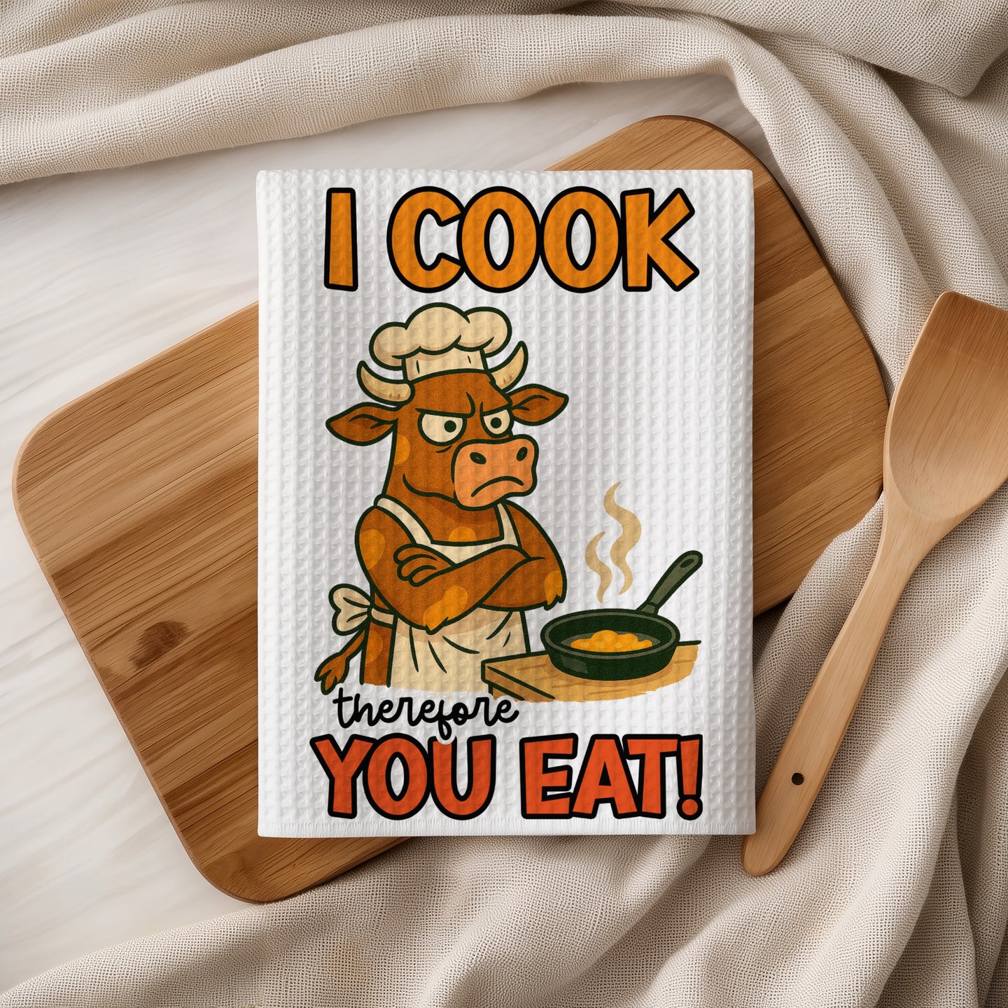 Waffle towel with cartoon cow chef text "I COOK therefore YOU EAT!".