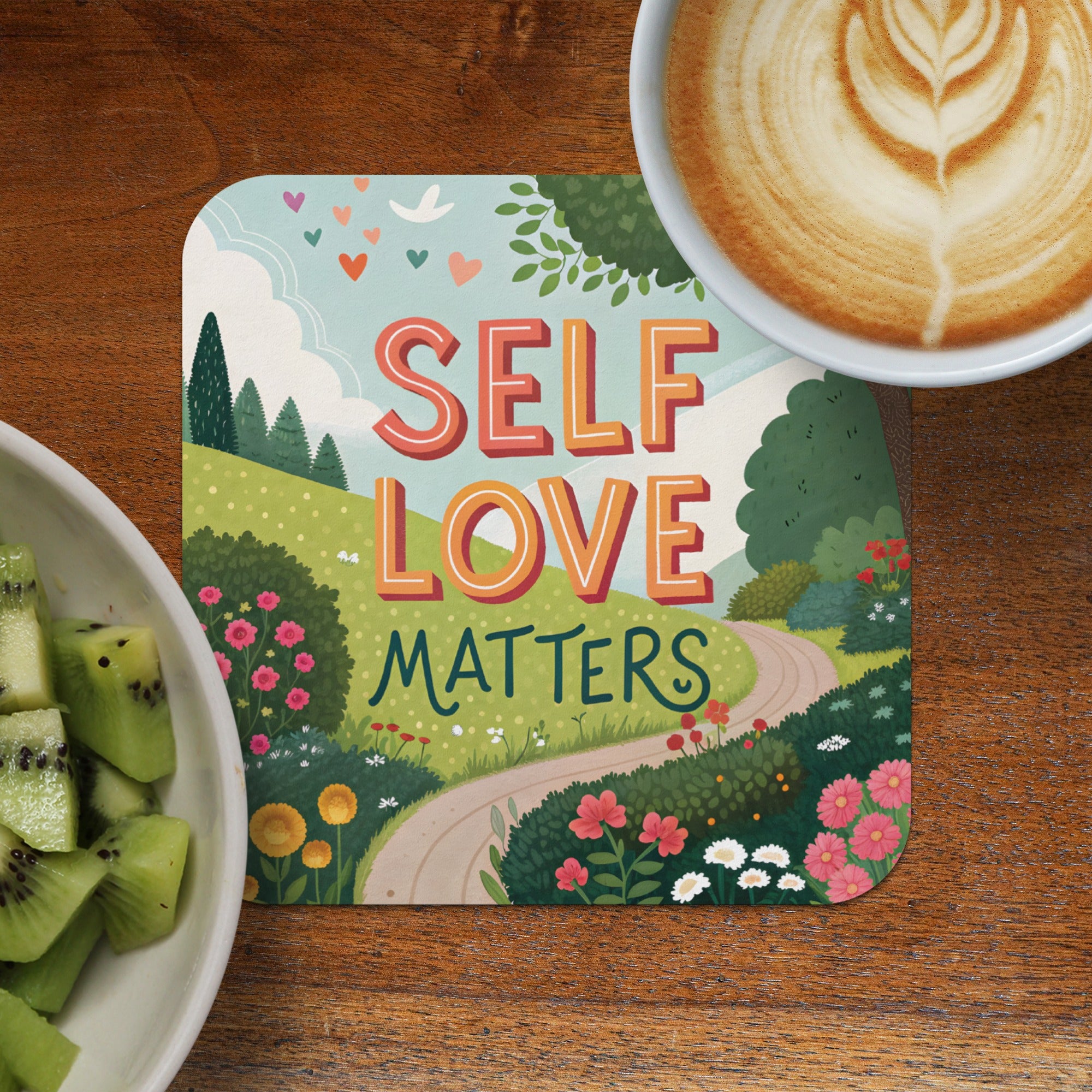 Coaster with "Self Love Matters" text, cheerful landscape, and cup of coffee.