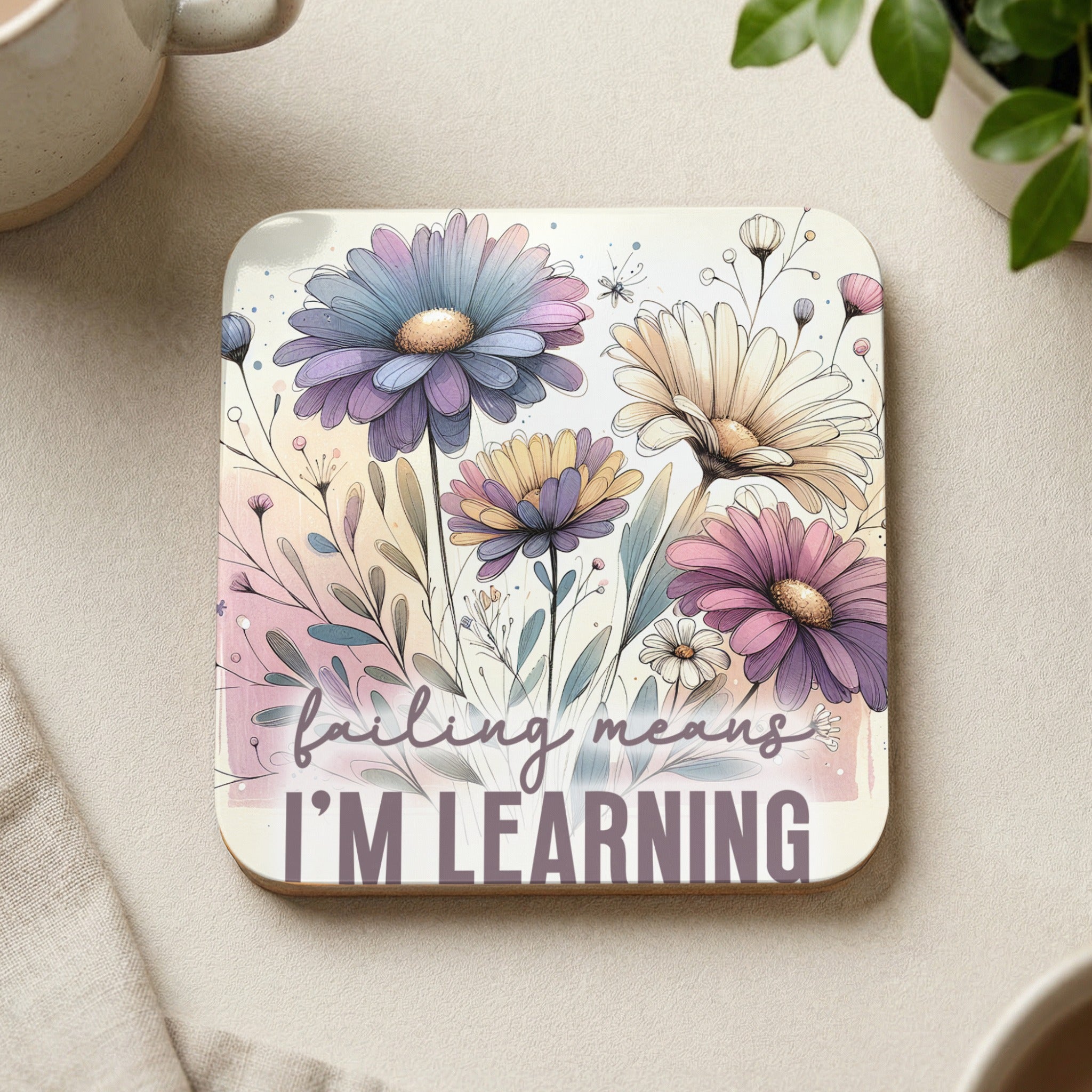 Square coaster with pastel flowers and text "failing means I'm learning".