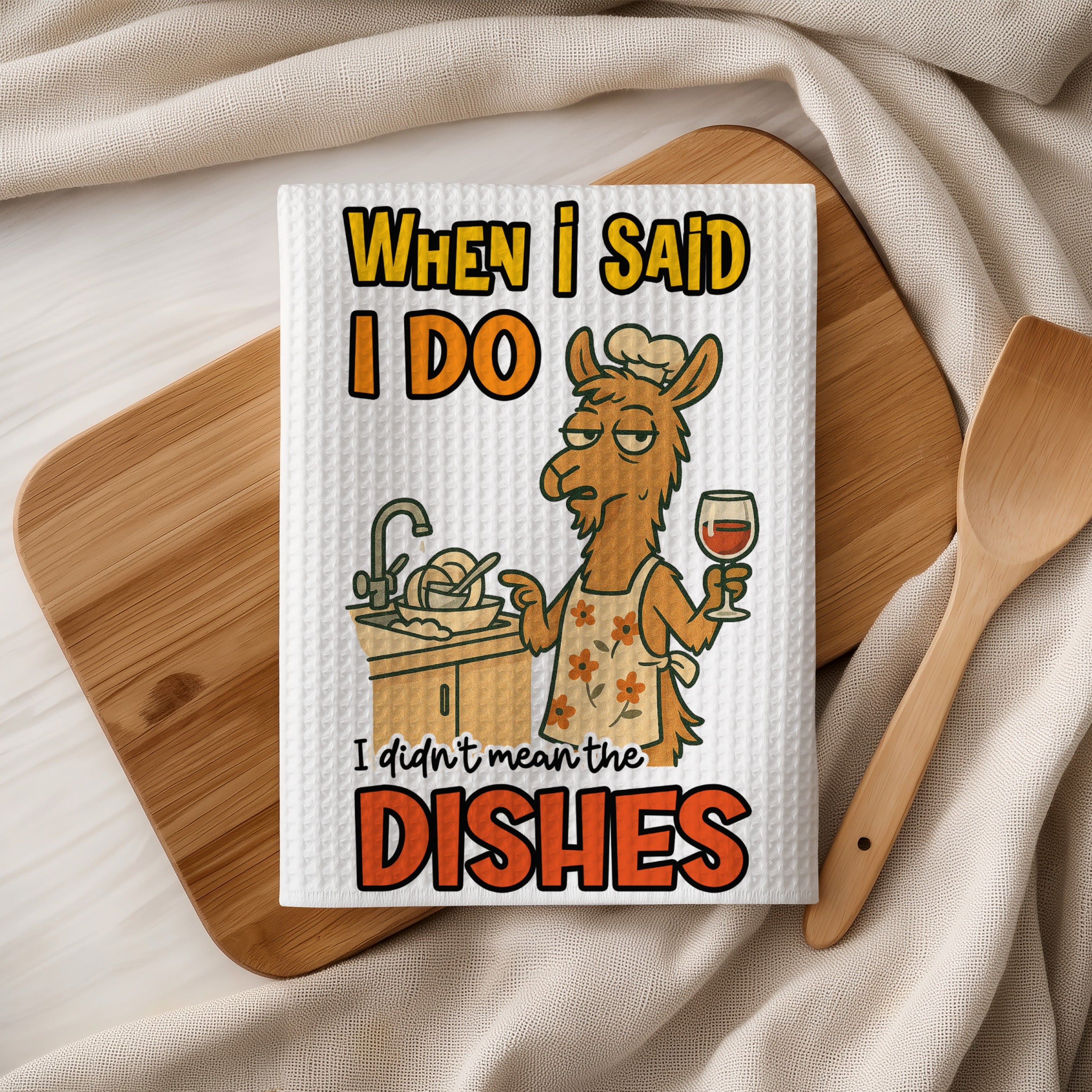 Waffle kitchen towel with llama wearing chef hat, holding wine, with text "When I said I do I didn't mean the dishes."