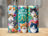 Three colorful tumblers featuring cats, butterflies, and flowers with text "Life is better with CATS".