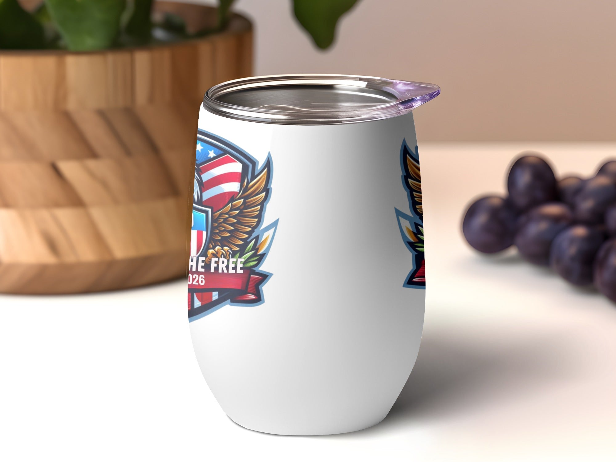 White tumbler with eagle emblem and "Land of the Free 1776" text.