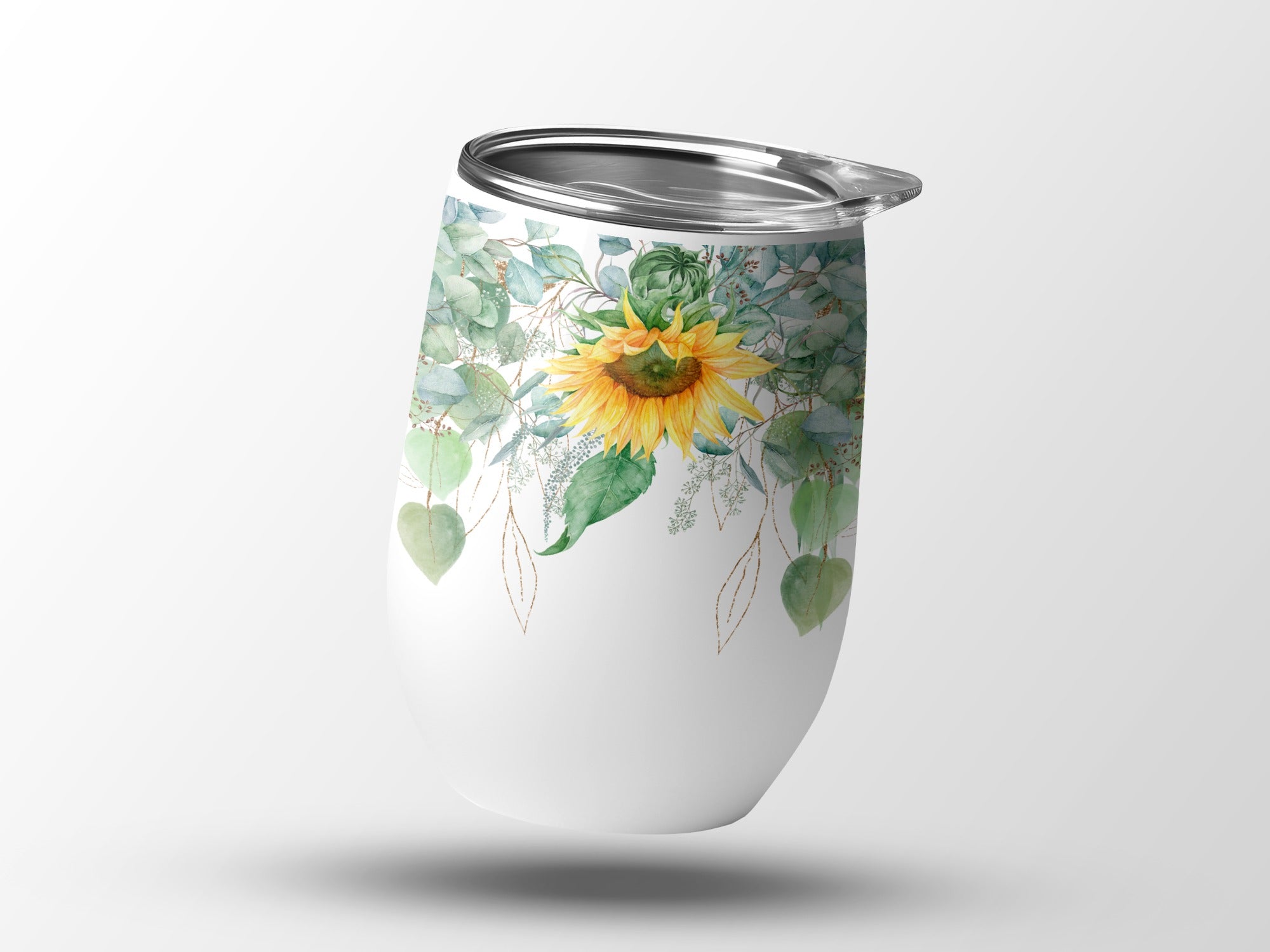 White tumbler with sunflower and eucalyptus leaf design.