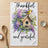Birdhouse with "Thankful and grateful" text, surrounded by flowers and greenery.