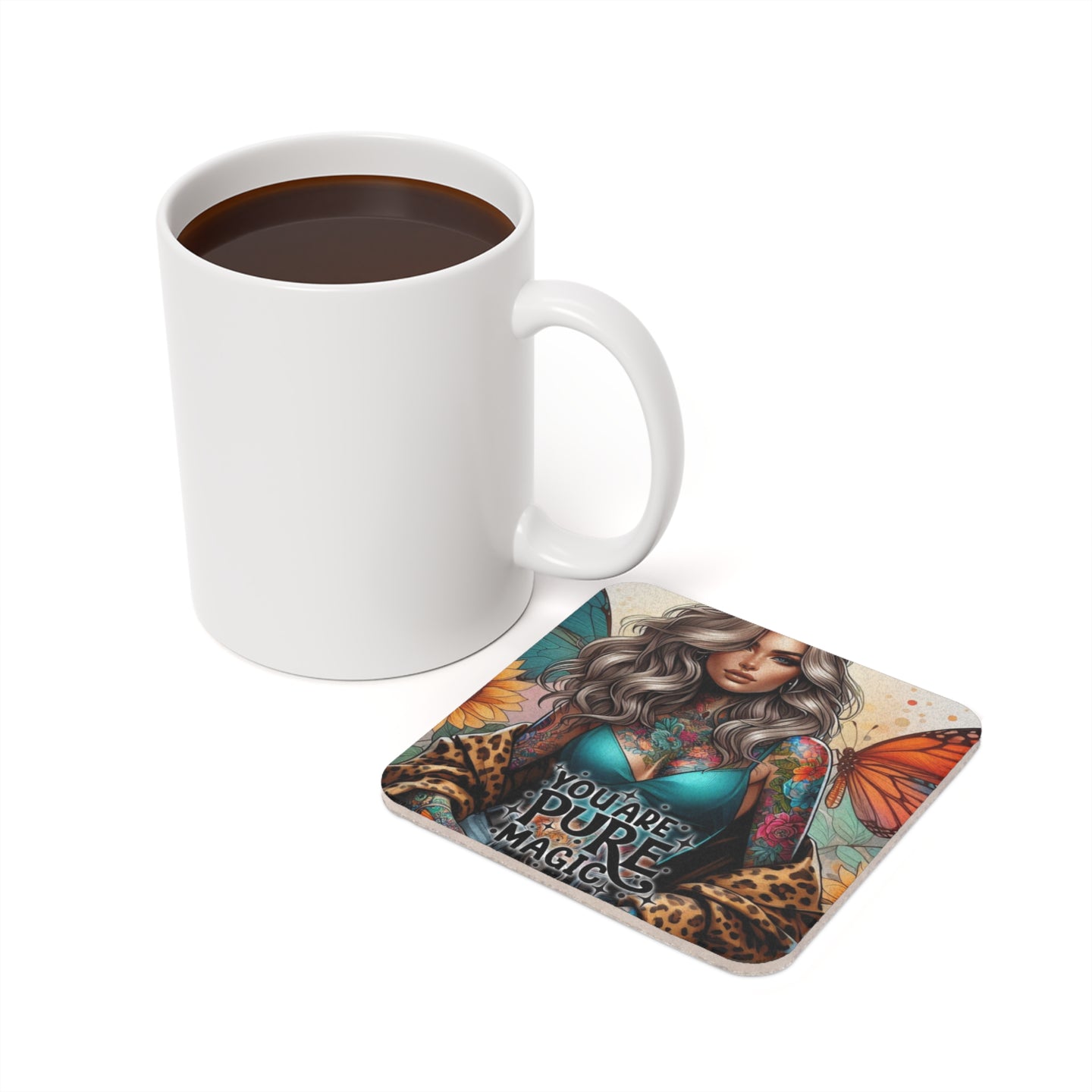 White mug of coffee next to coaster with tattooed woman and butterflies.