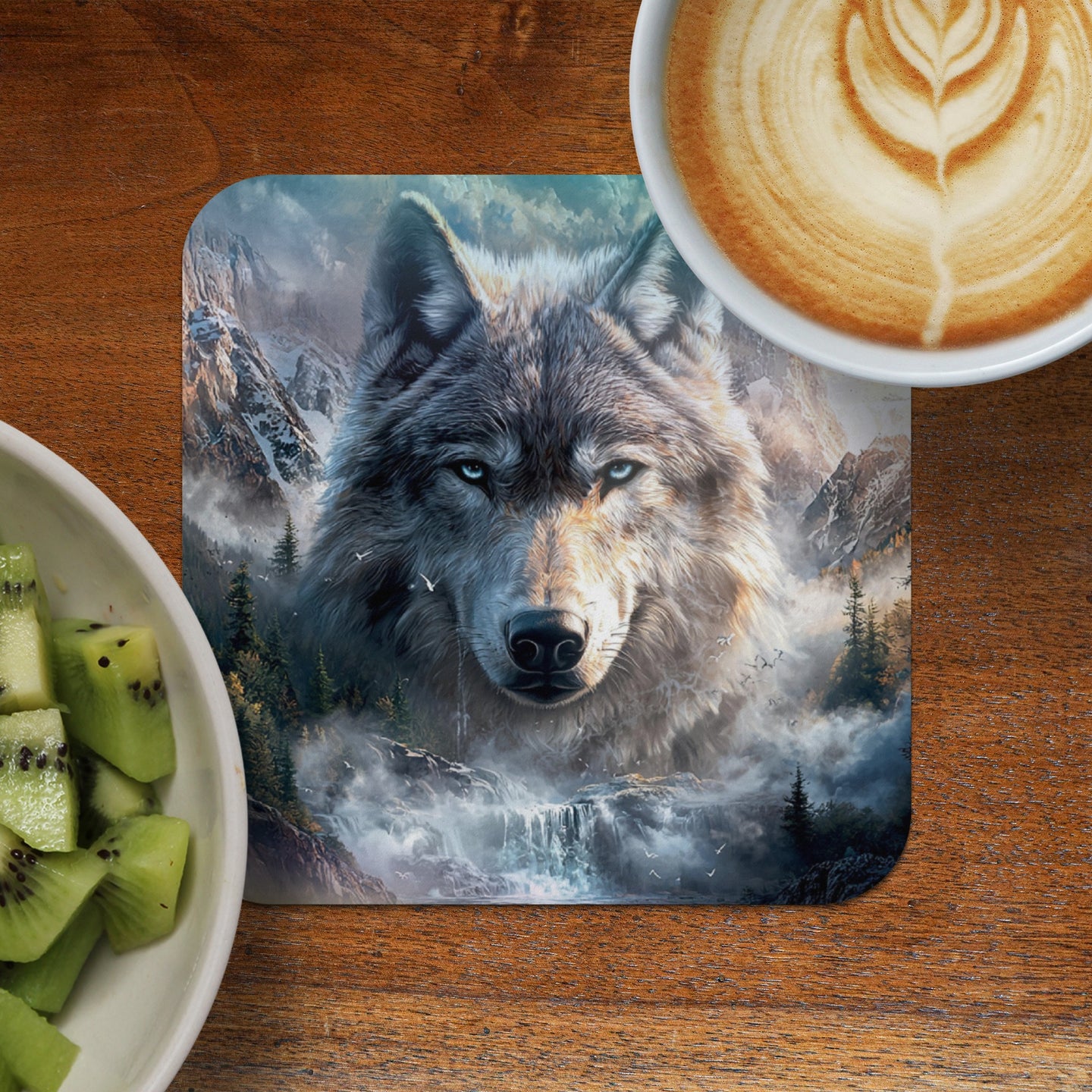 Wolf art coaster with coffee and kiwi fruit on a wooden table.