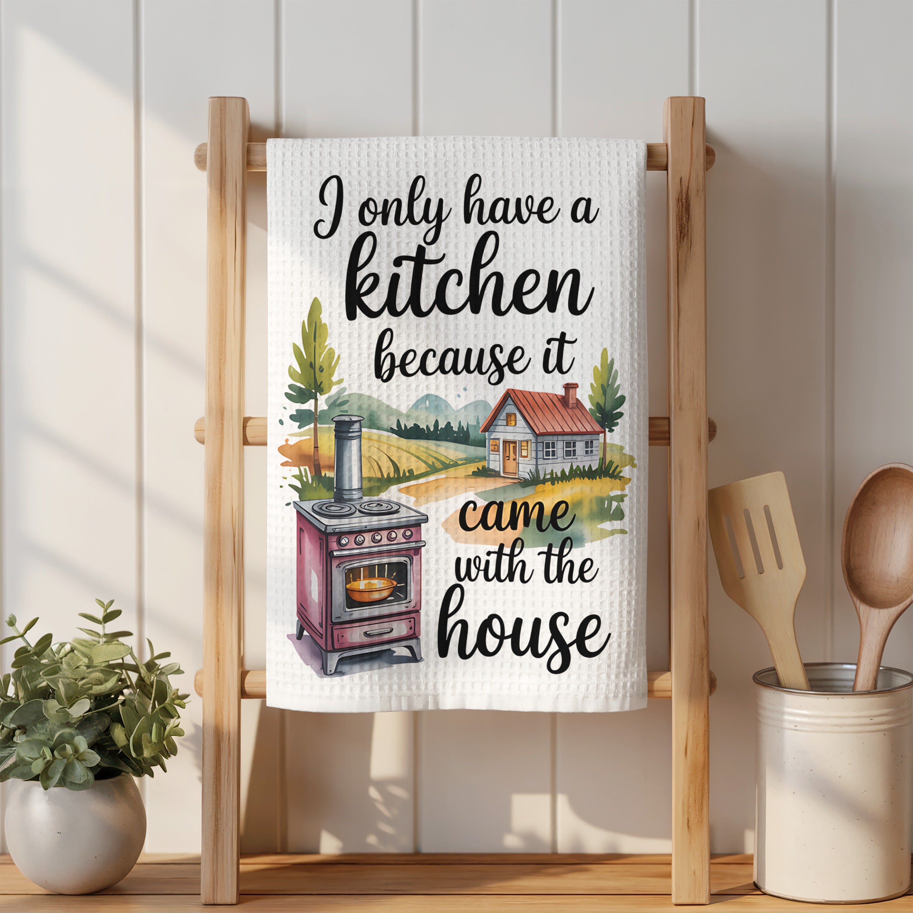 Kitchen towel with a watercolor house, stove, and text.