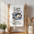 White kitchen towel with "I cook therefore you eat" text, frying pan, and daisies.