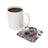 White mug of coffee next to a square coaster with a tattooed woman and "trust the process" text.