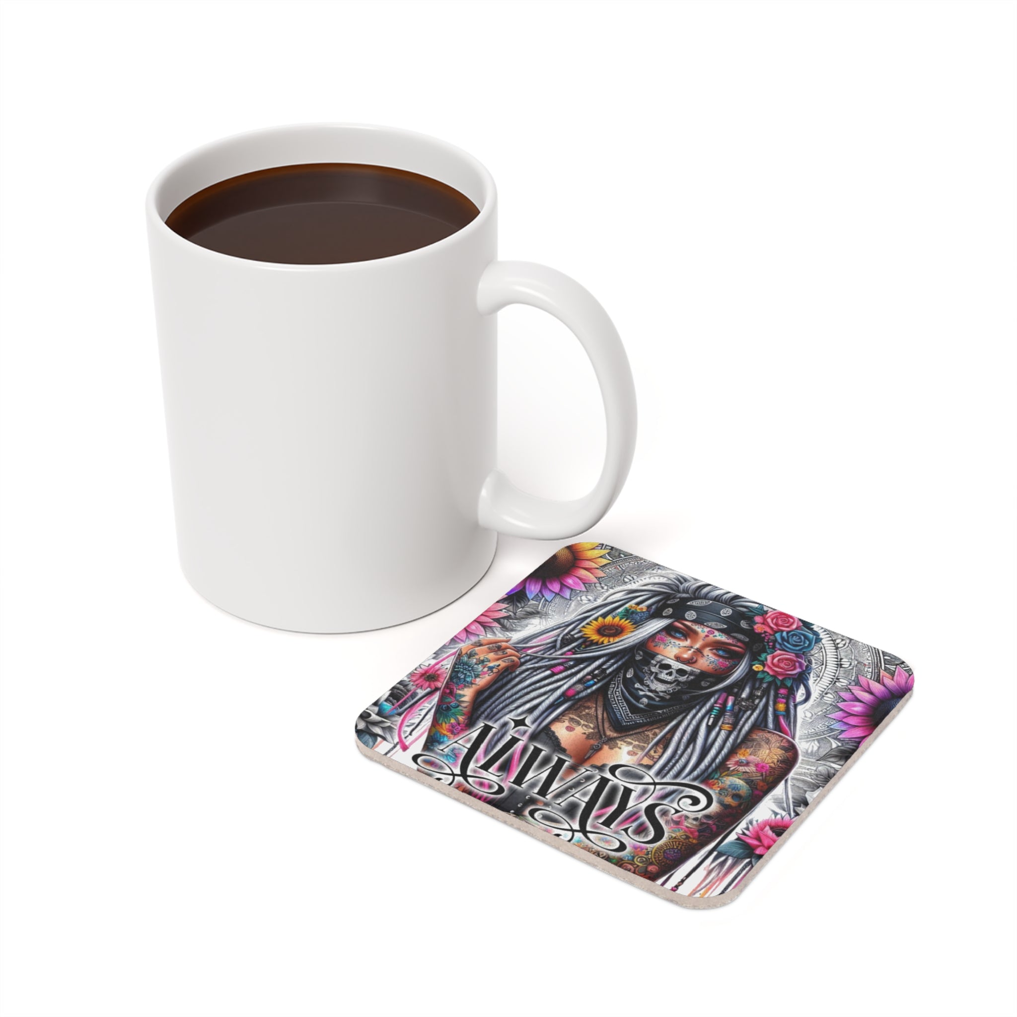 White mug with coffee next to a coaster featuring a tattooed woman with flowers.